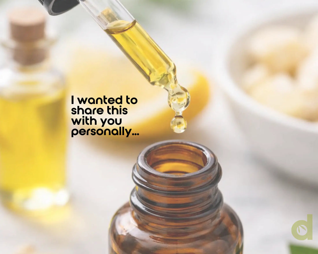 A dropper dispensing oils into a small amber jar.