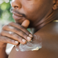 man applying a oatmeal salve to their shoulder outdoors